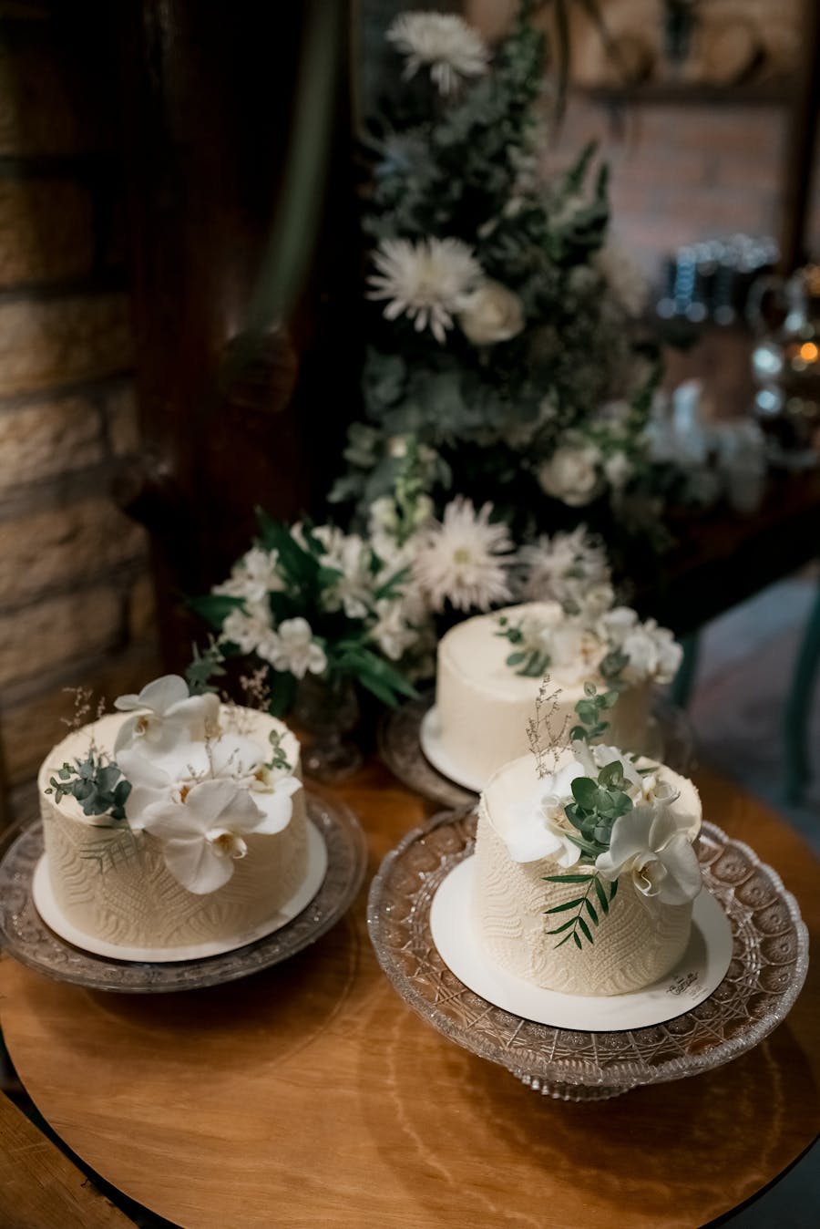 Elegant white fondant wedding cake with gold leaf accents